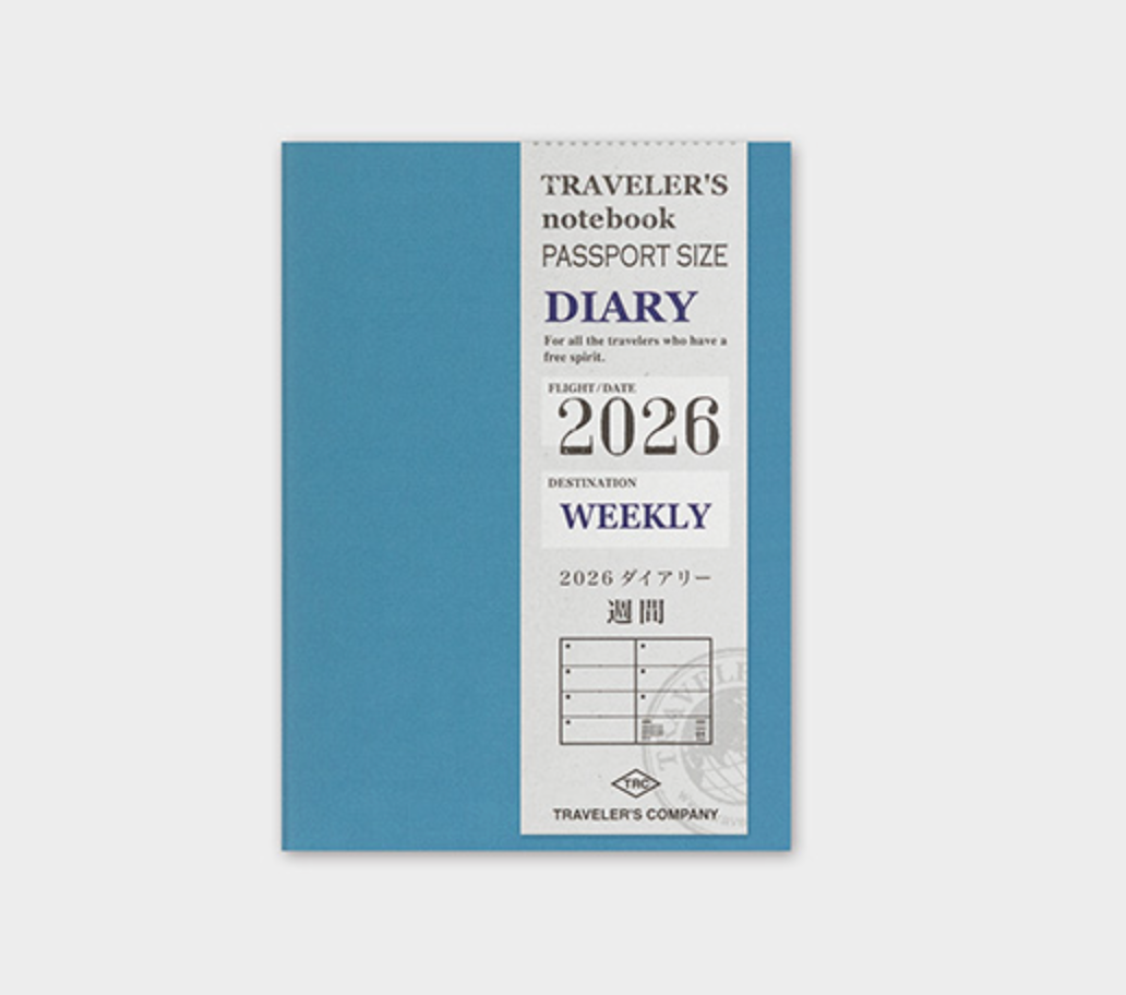 Blue travel notebook with 'Traveler's Company' branding on a light gray background