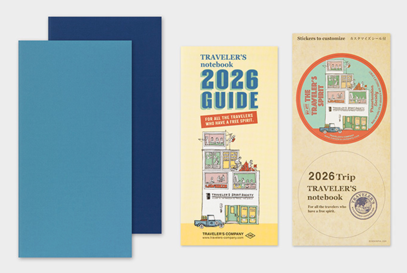 Two blue notebooks and two packages of 'Traveler's Company' notebooks with 2026 guides and stickers on a white background.