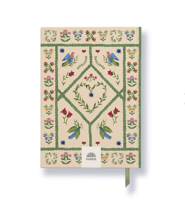 Notebook with floral and bird design on a beige background, featuring the brand 'Papier'.