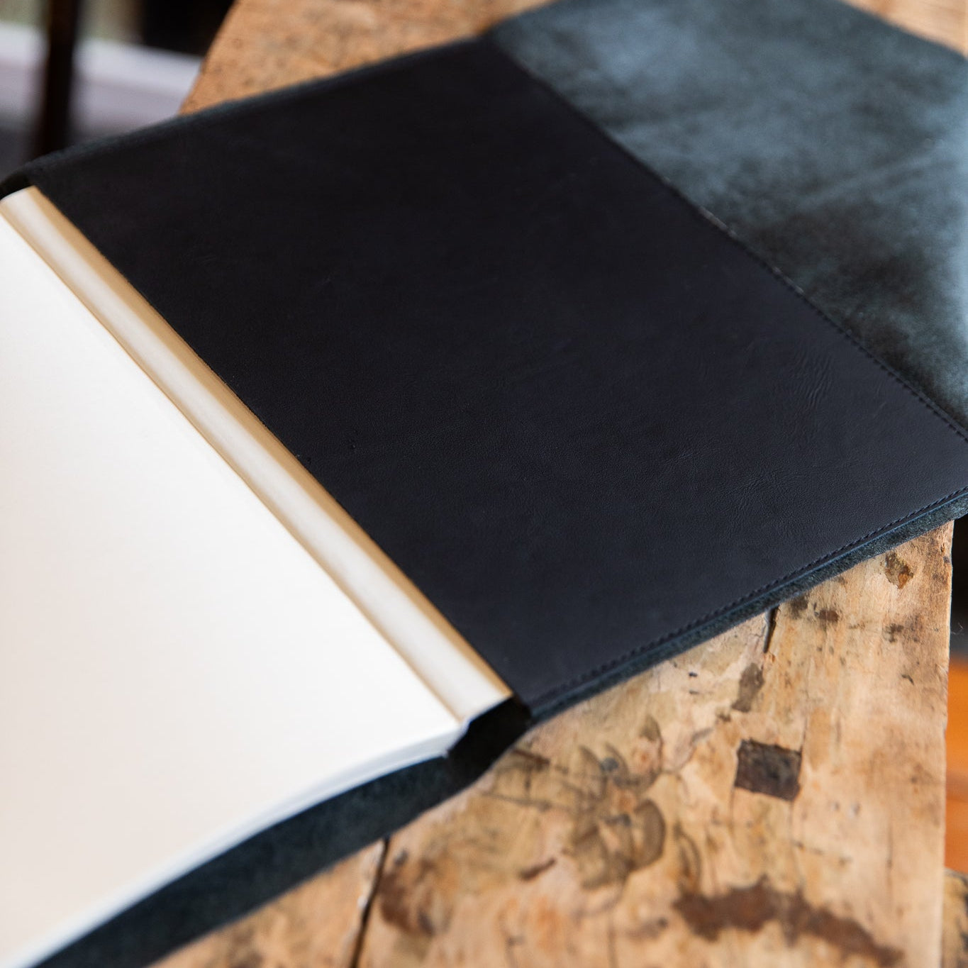Black-leather wrap pocket on a wooden surface