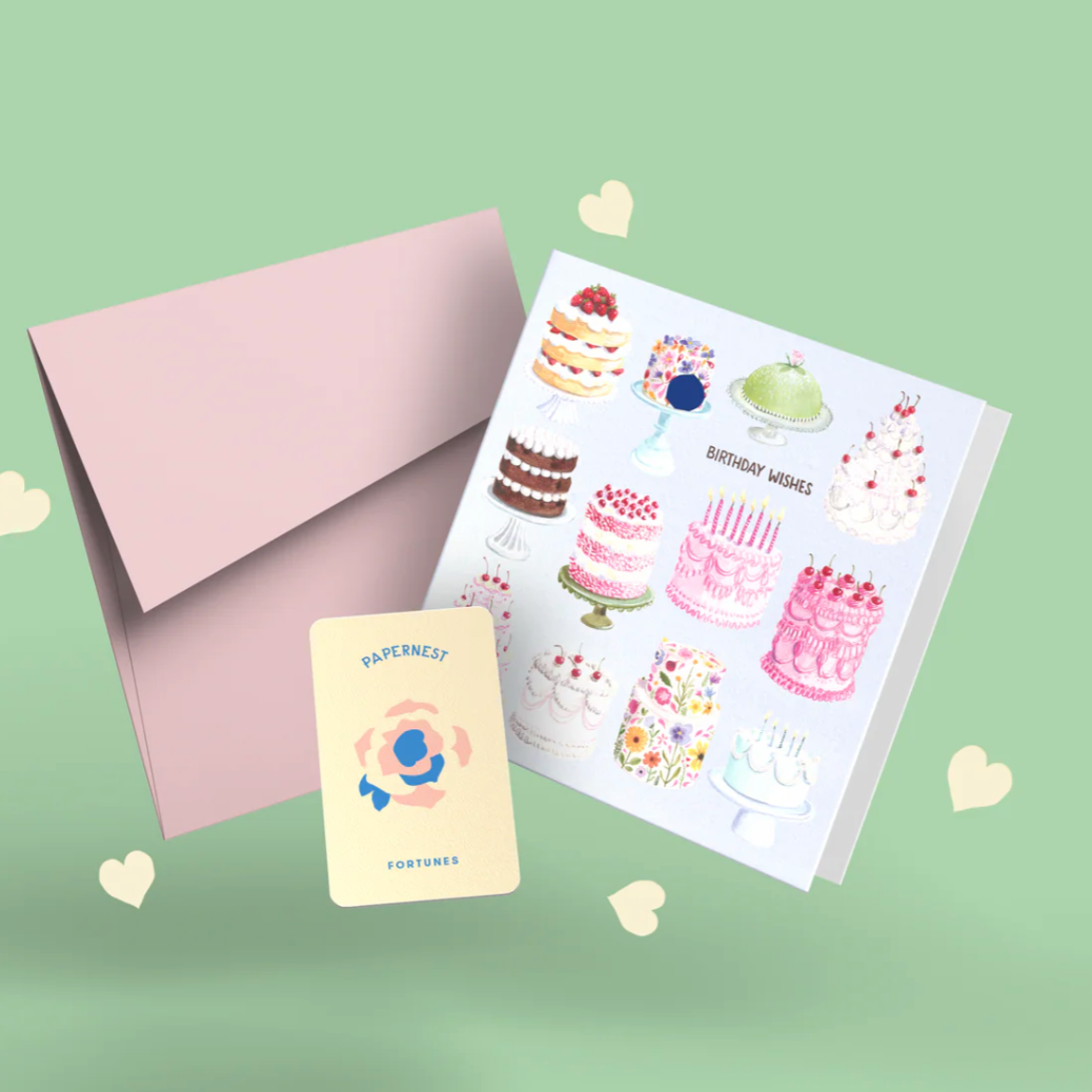 Greeting card with cake illustrations and a pink envelope on a light green background