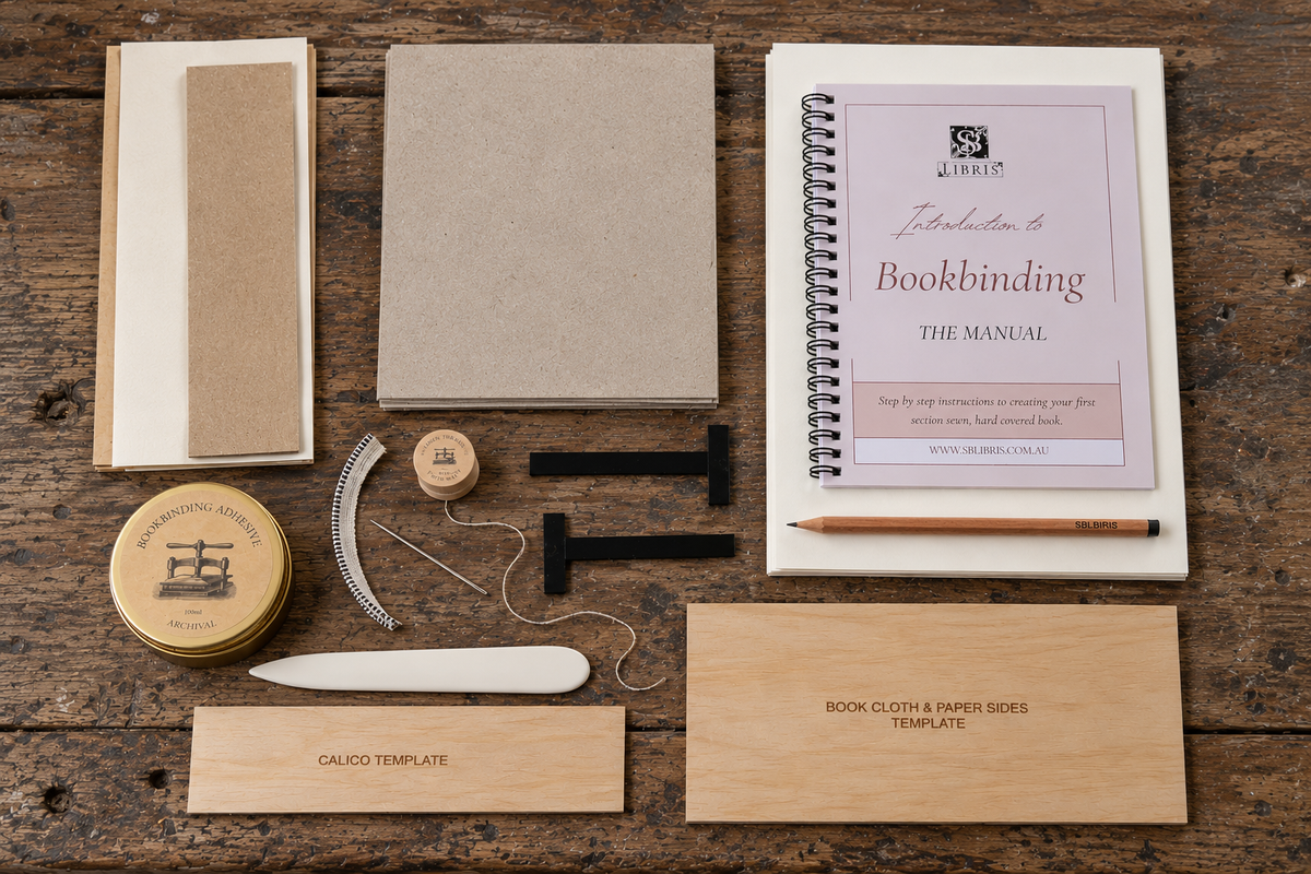 Contents of the SB Libris Beginners Bookbinding Kit laid out on a timber workbench