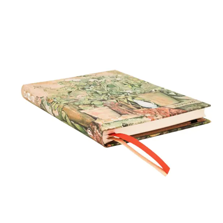 Decorative notebook with a floral design on the cover, open to a blank page.