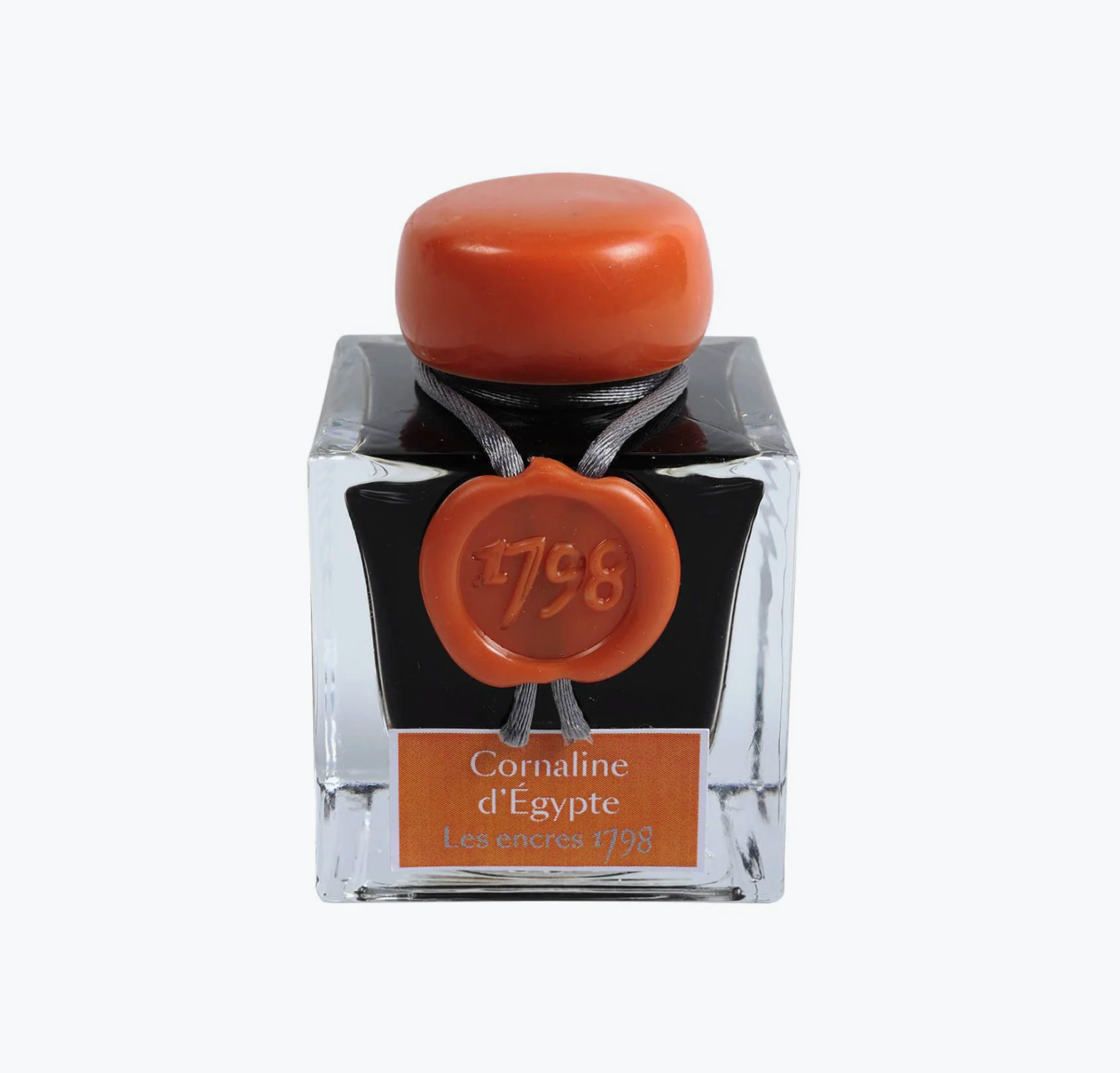 Ink bottle with orange cap and label on a white background