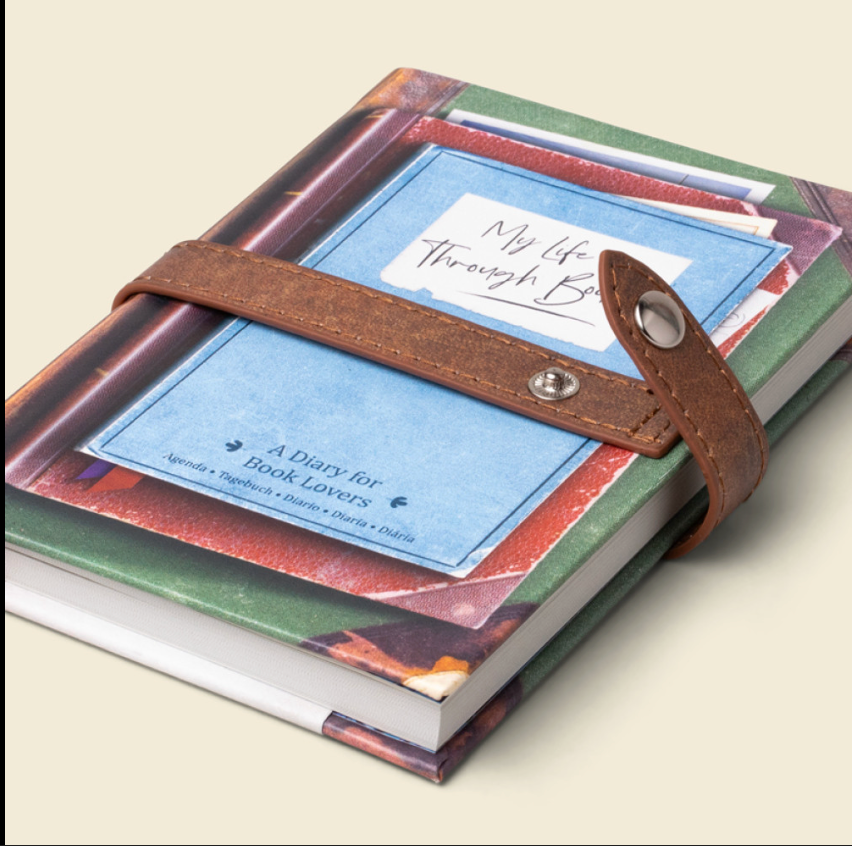 Diary with a leather strap on a beige background