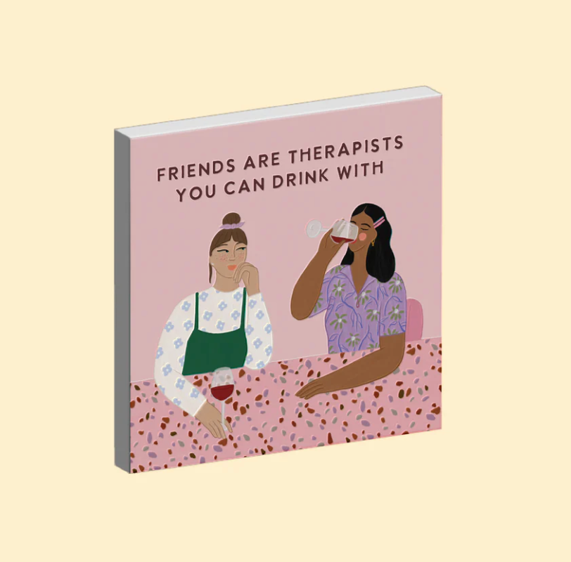 Ceramic magnet with illustration of two women and text 'Friends are therapists you can drink with' on a pink background