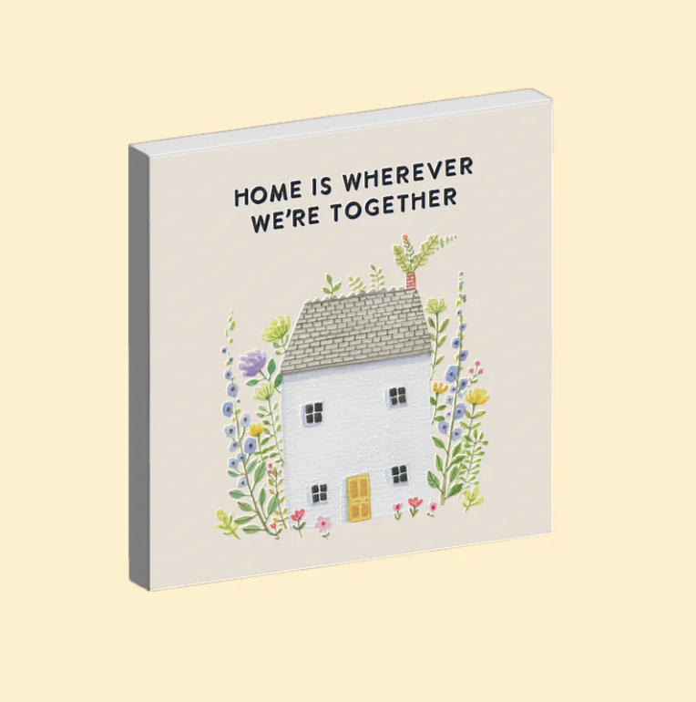 Magnet with a house illustration and 'Home is wherever we're together' text on a beige background