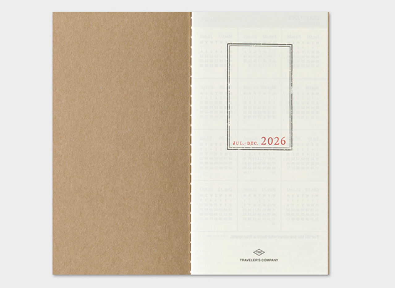 Two notebooks, one brown and one white with text, on a light gray background.
