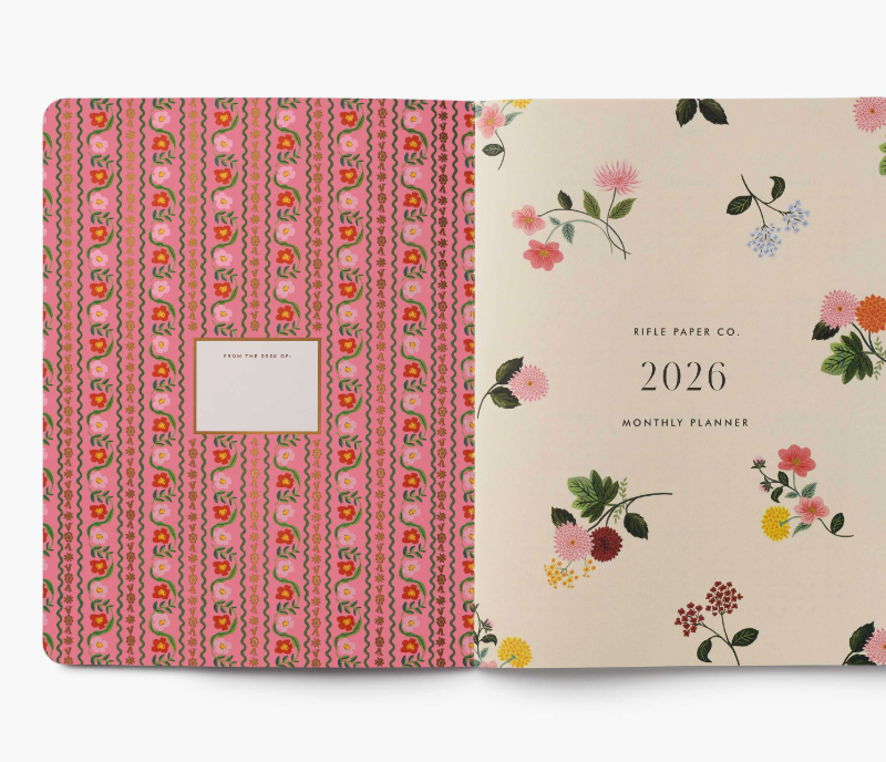 Two planners with floral designs on a white background