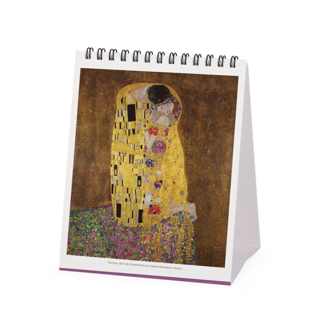 Desk calendar with 'The Kiss' by Gustav Klimt on a white background