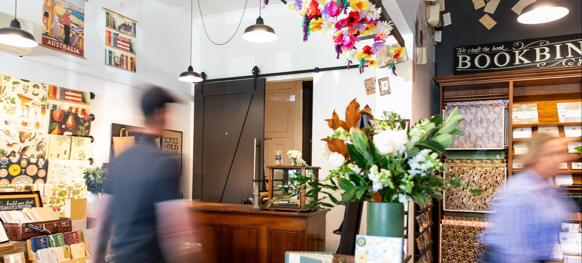 Interior of a store with bookshelves, decor, and people browsing.