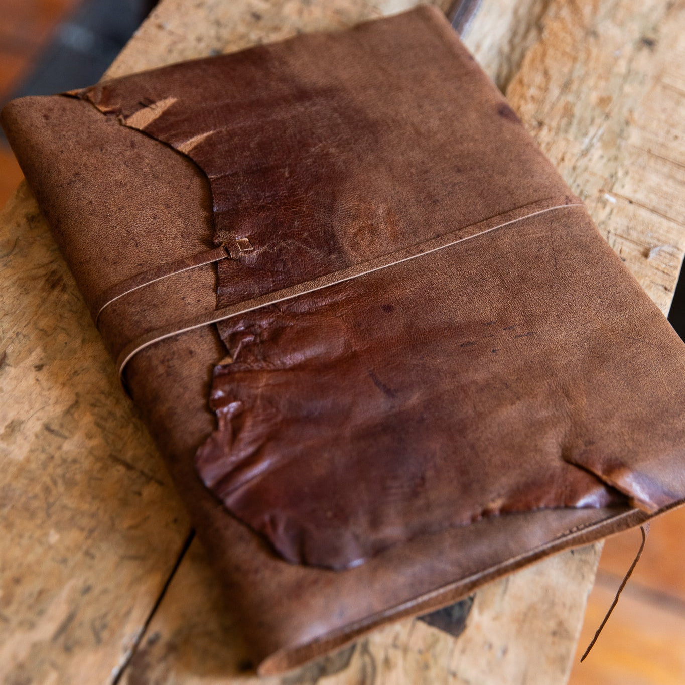 Brown leather-bound book on a wooden surface