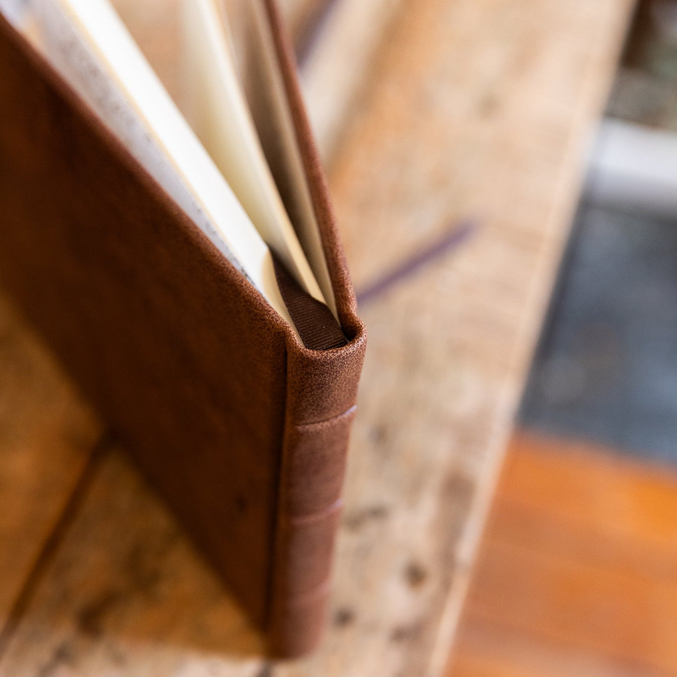 Brown leather notebook on a wooden surface