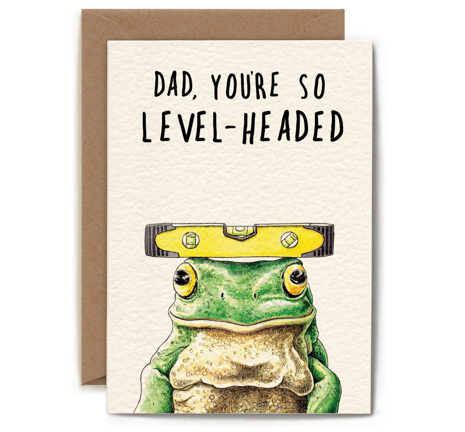 A greeting card with a brown envelope behind it, featuring the text 'DAD, YOU'RE SO LEVEL-HEADED' above an illustration of a green frog wearing a yellow spirit level on its head.