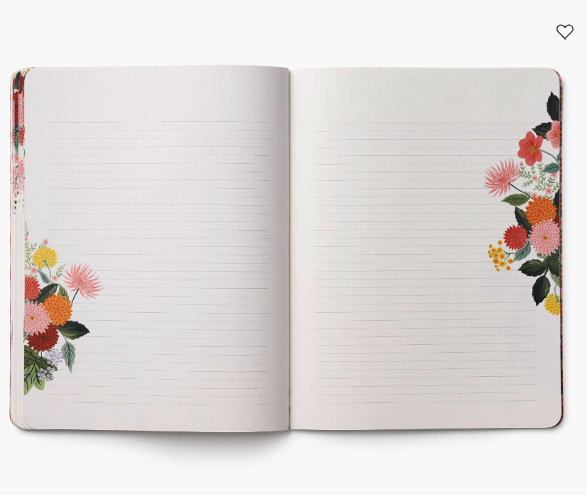 Open notebook with floral designs on the cover and edges