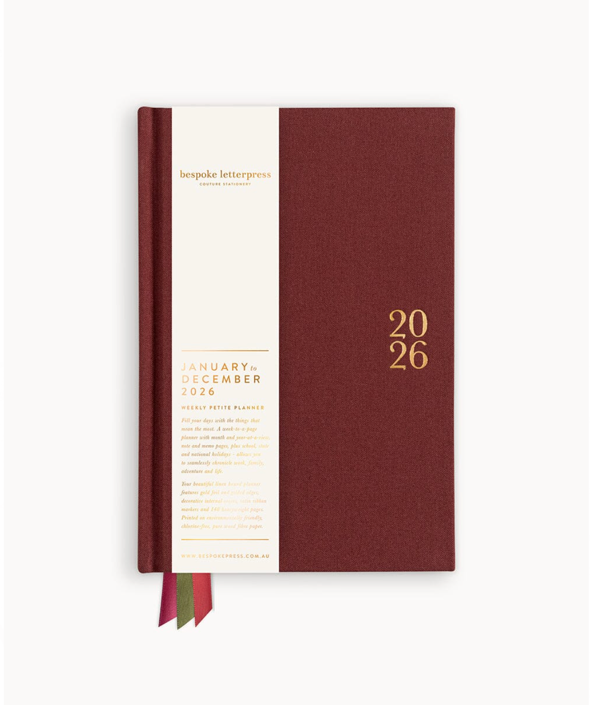 Maroon planner with white front cover displaying '2026' on a white background