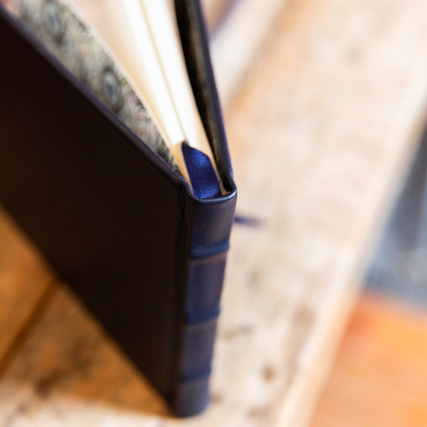 Close-up of a navy signature book on a textured surface