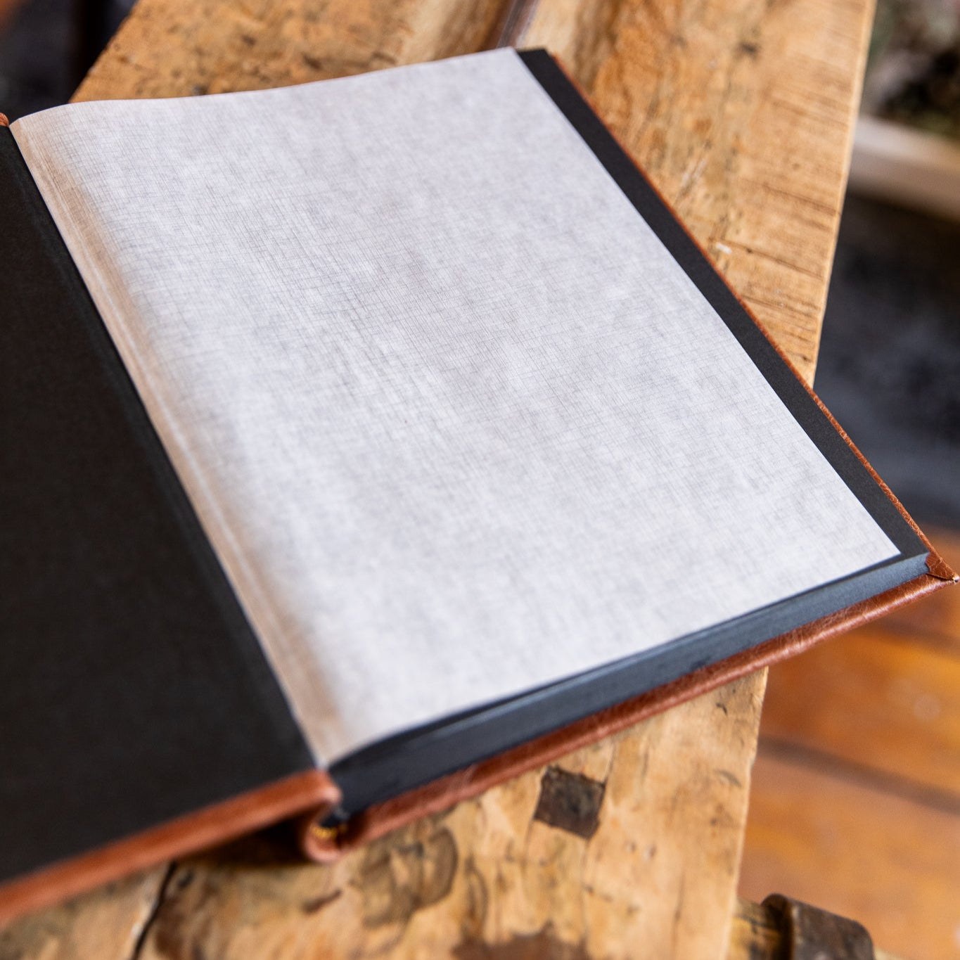 Open album on a wooden surface with a blurred background