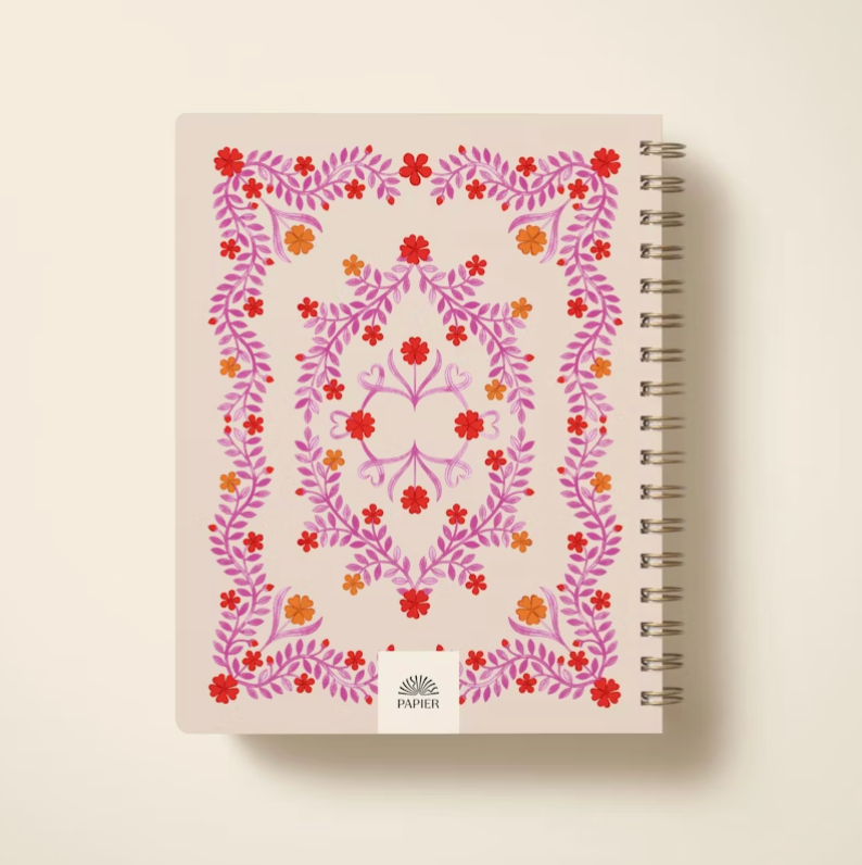 Notebook with floral design on a beige background