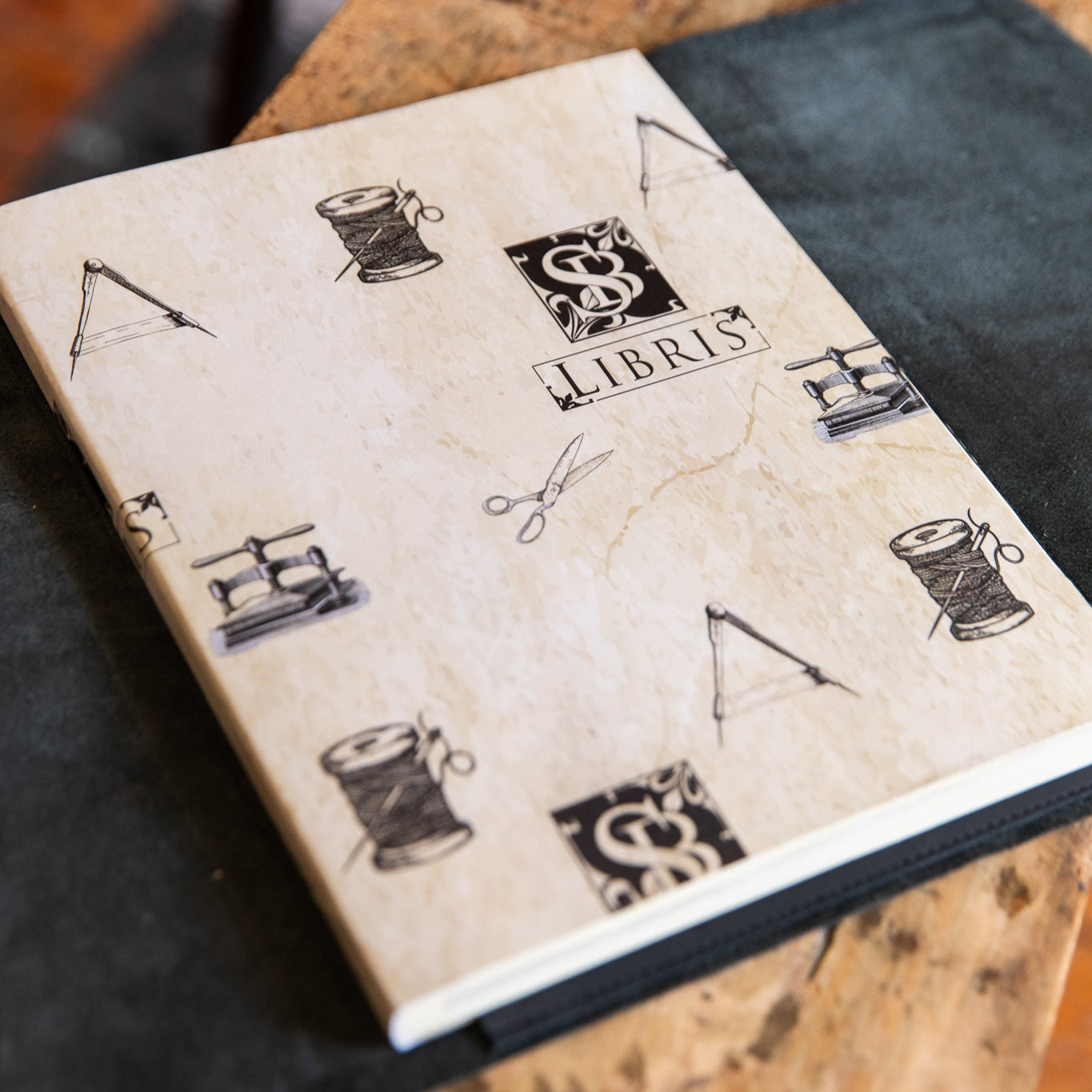 Notebook with decorative cover on a wooden surface