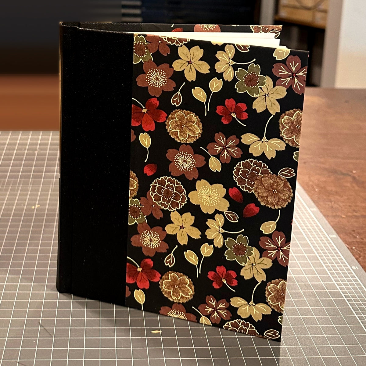 Finished A5 hardcover journal made with the SB Libris Beginners Bookbinding Kit, standing upright in the bindery
