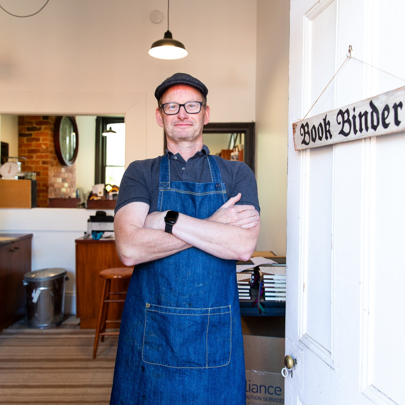 Simon Dart Bookbinder standing in the door of the bindery