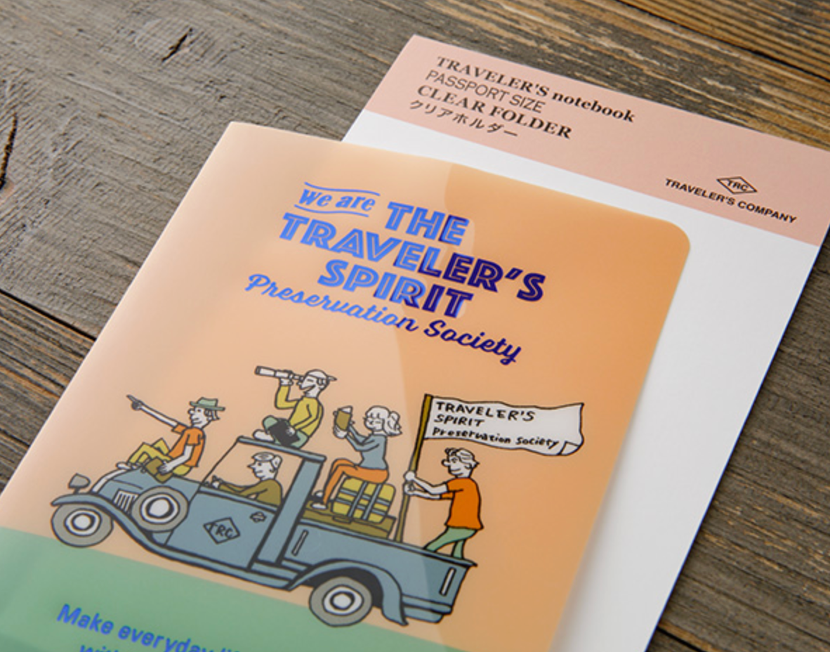 Traveler's notebook with illustration on a wooden surface