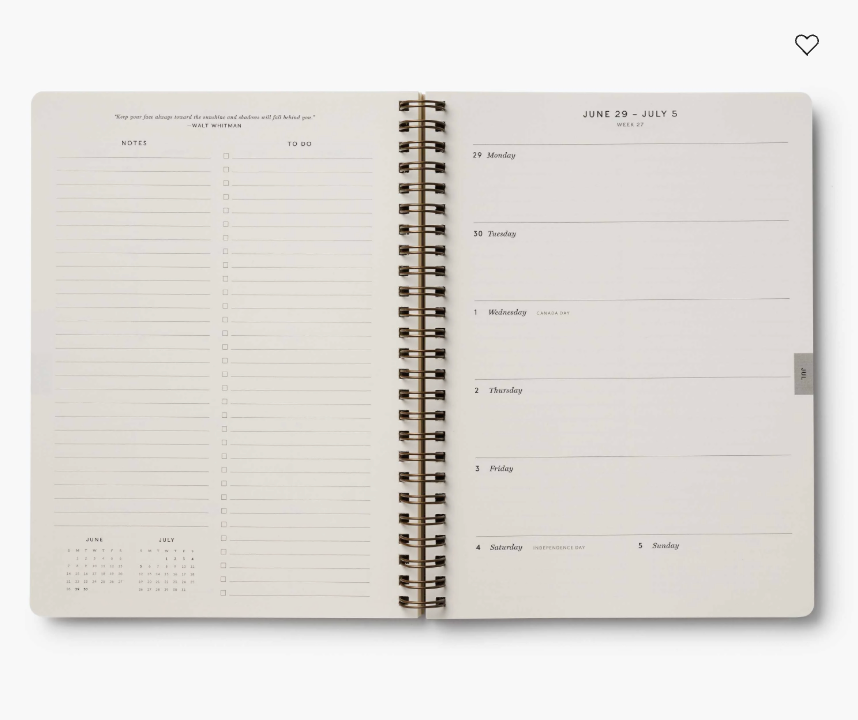 Open spiral-bound planner with a weekly layout on a white background