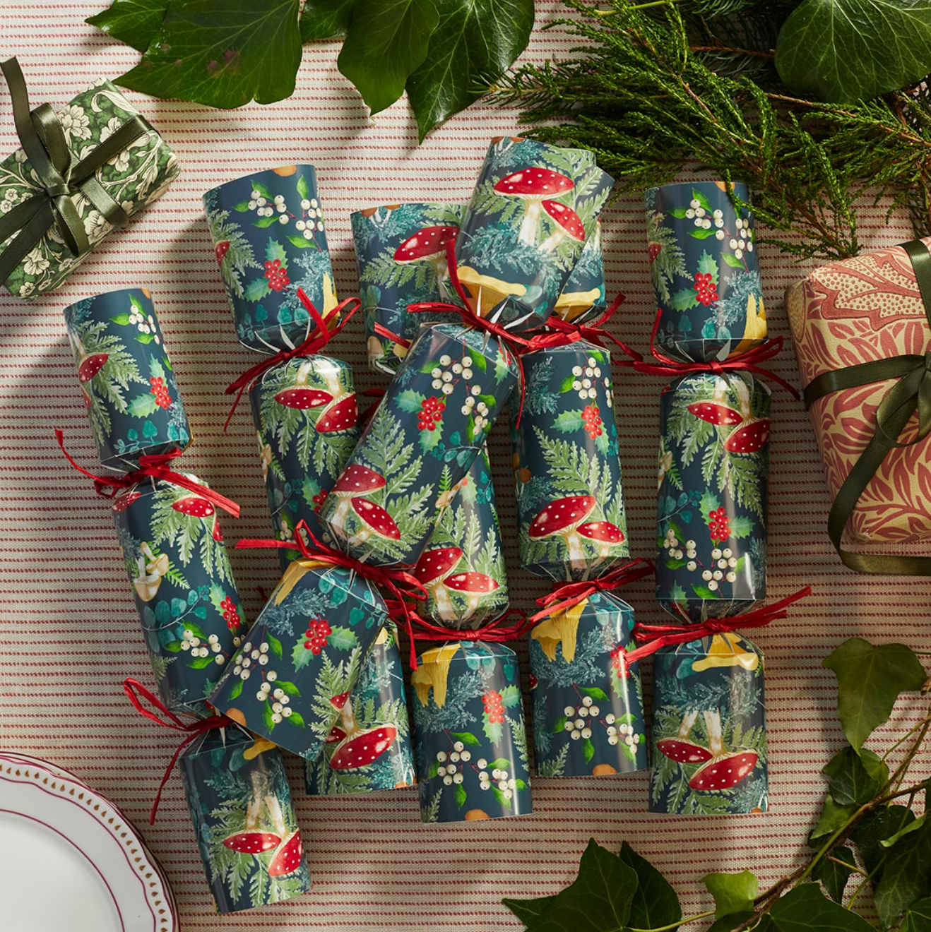 Decorative Christmas crackers with festive patterns on a textured surface.