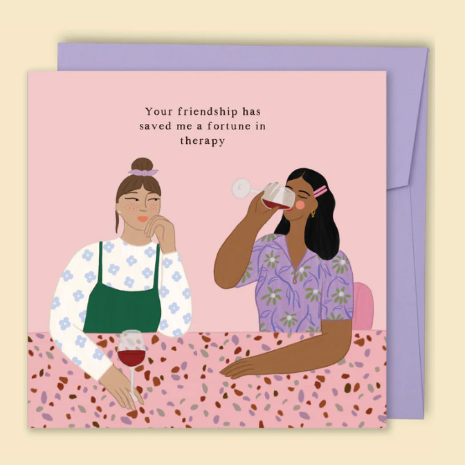 Card with illustration of two women sitting together and text about friendship, on a pink background with a purple envelope.