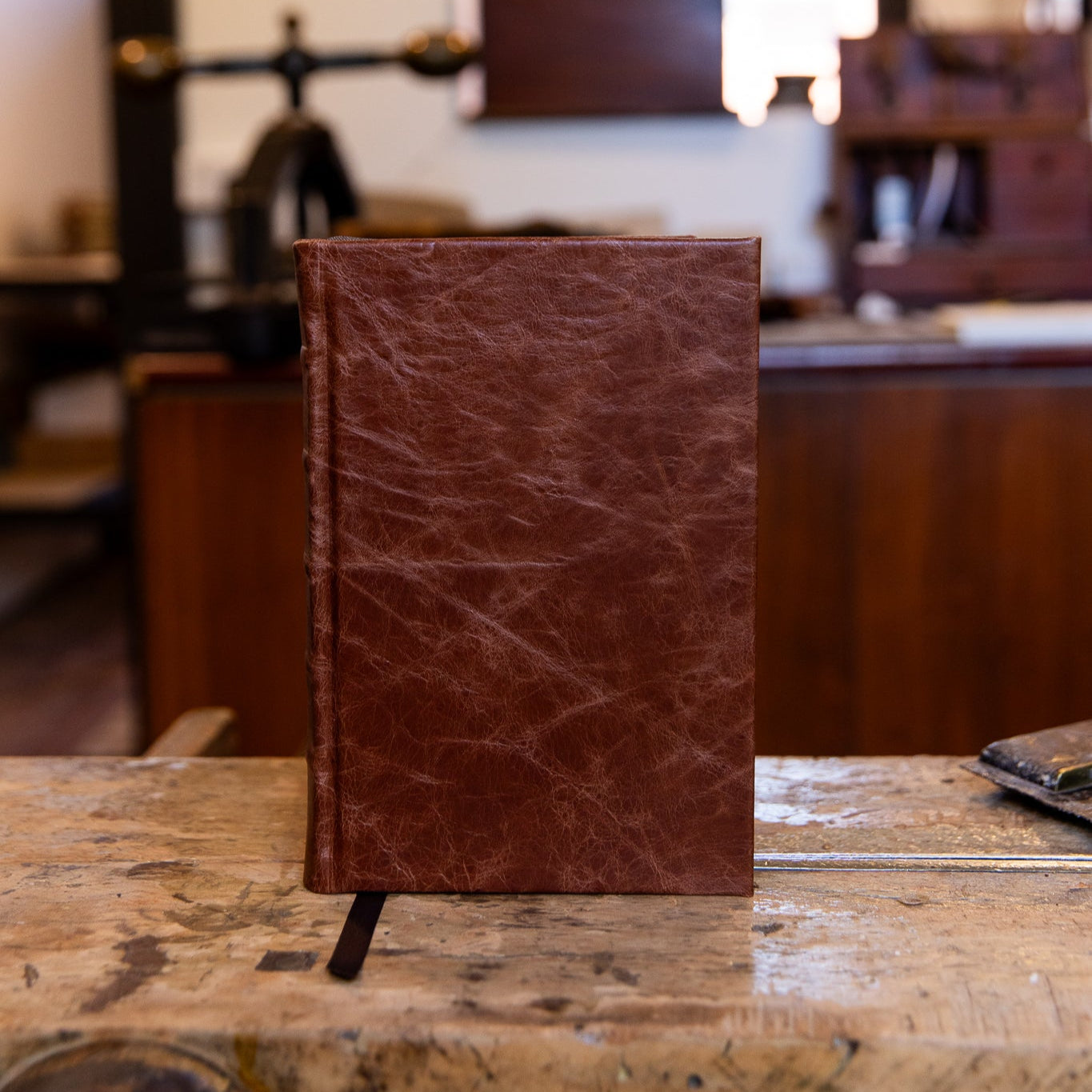 Small SB Libris Classic Journal in chestnut leather, standing upright with visible grain and subtle natural character.