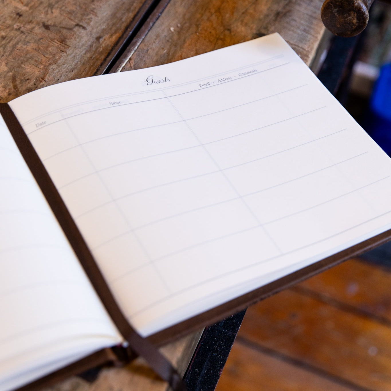 Interior view of the SB Libris aged goatskin guest book showing printed columns for date, name, email, address, and comments.