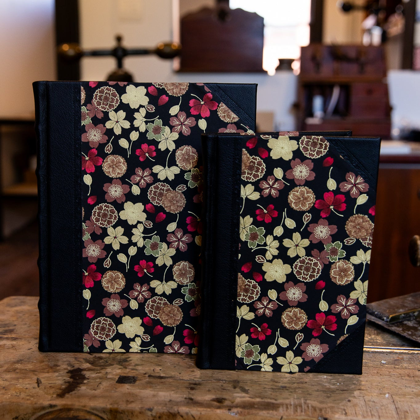 Large and small SB Libris half leather journals with black leather and Japanese golden flower patterned paper.