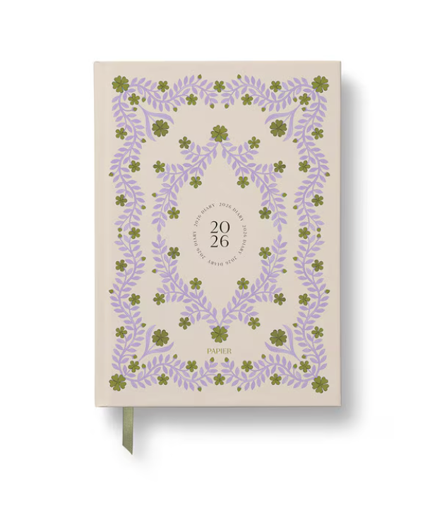 Notebook with floral design and '2026' text on a beige background