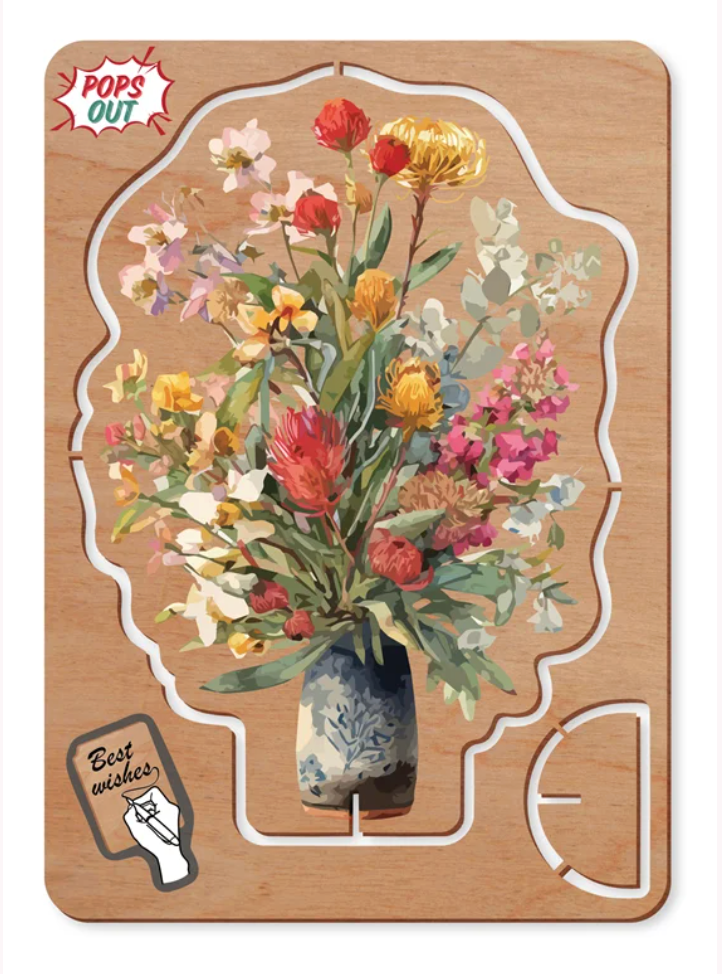 A wooden pop up card with a floral design of a vase of mixed flowers, featuring a 'POPS OUT' label in the top left and a 'Best enjoyed.' sticker on the bottom left.