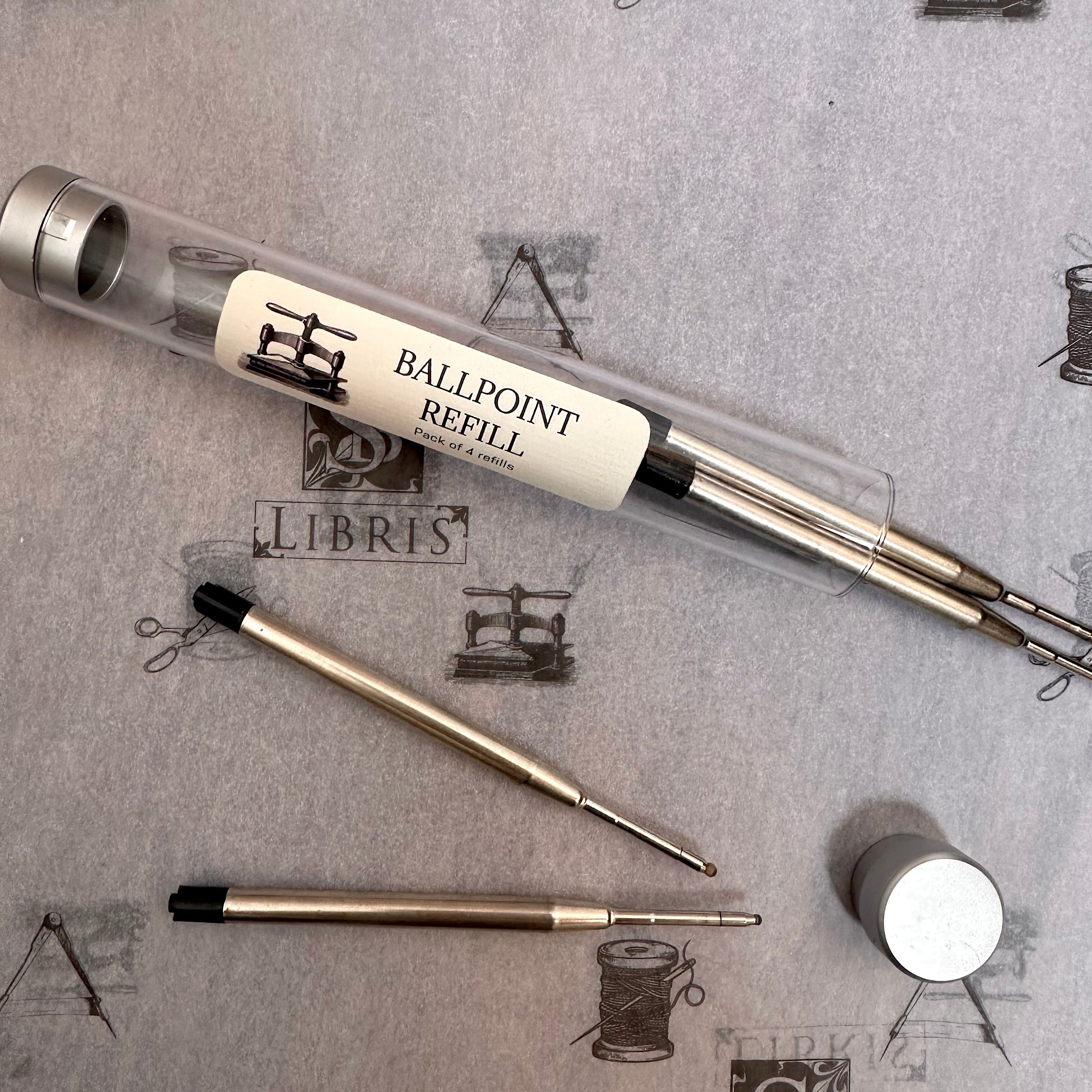 Pack of four black ballpoint refills on a white background