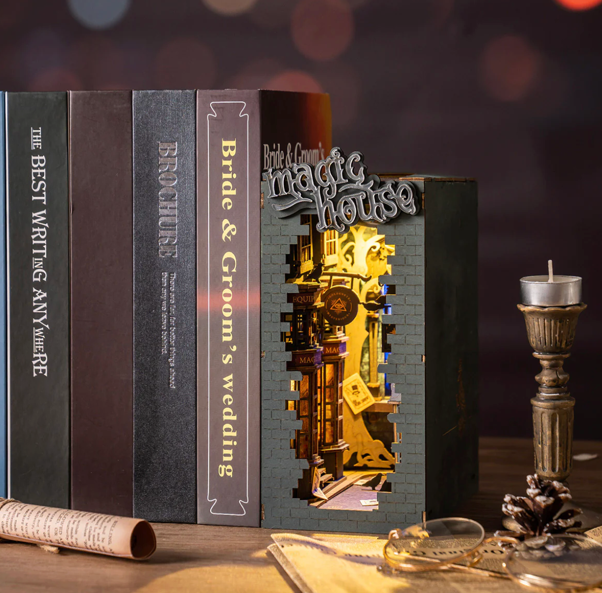 Decorative book with a gold interior and 'Bride & Groom's Magic House' text, surrounded by books and decorative items.