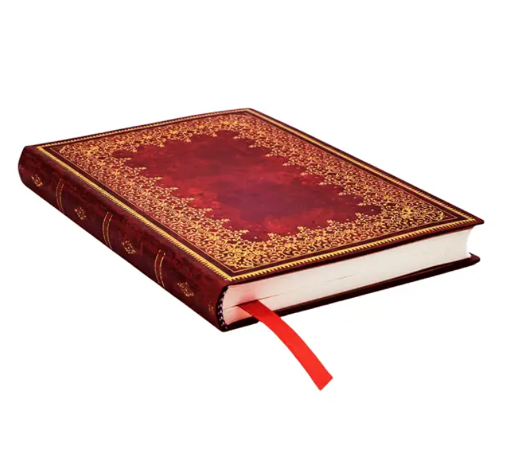 Decorative planner with a red ribbon and gold foiling on a white background
