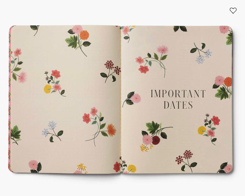 Open notebook with floral design and 'Important Dates' text on a beige background