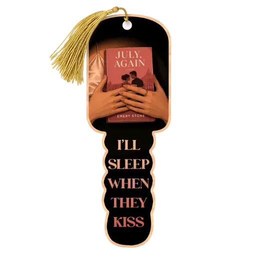 A novelty key-shaped bookmark with a gold tassel. The bookmark features a black background with the text 'I'LL SLEEP WHEN THEY KISS' in rose gold.