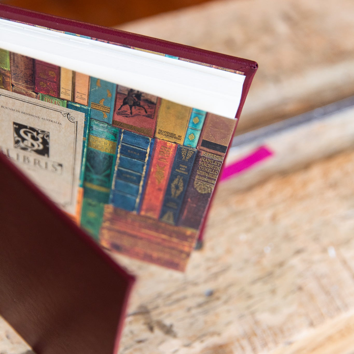 Close-up of a book with a book endpaper design on a wooden surface.