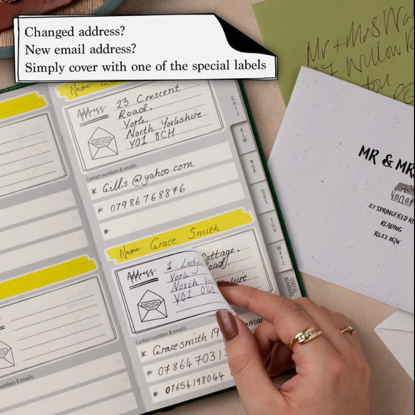 Address labels being applied to envelopes with text about changing addresses.