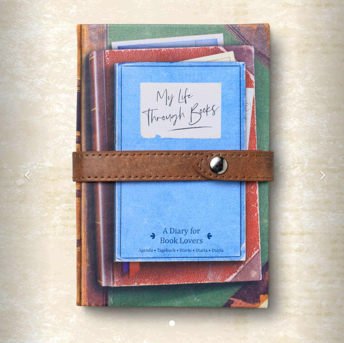 Notebook with a leather strap titled 'My Life Through Books' on a textured beige background