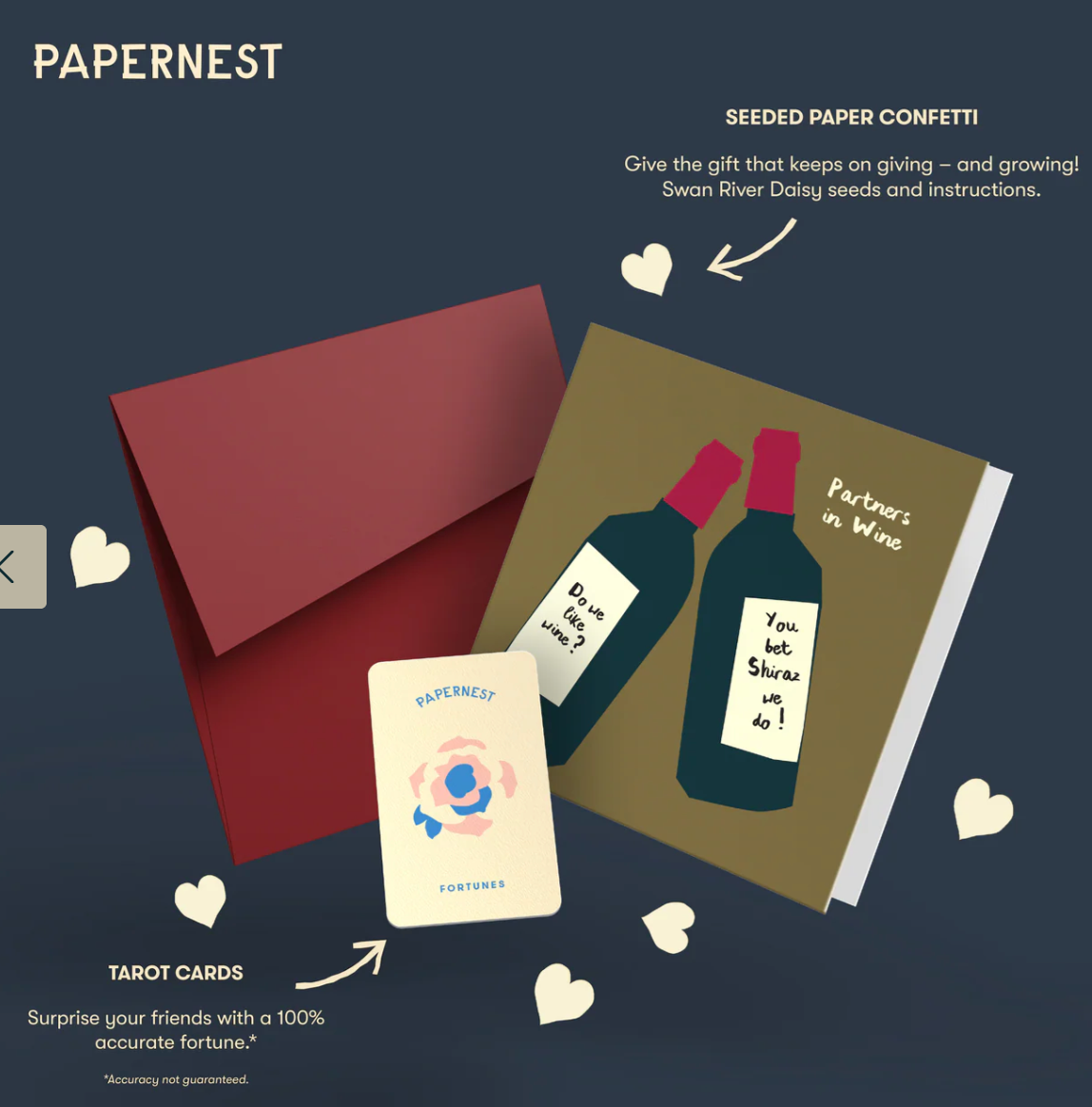 Papernest product set with tarot cards, seed paper confetti, and a book on a dark background
