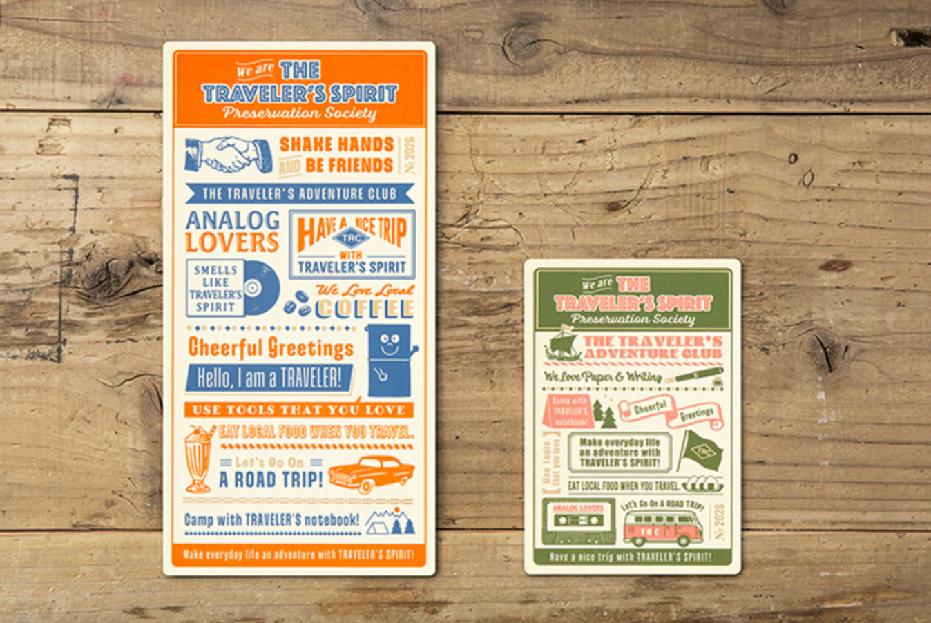 Two travel-themed posters on a wooden surface