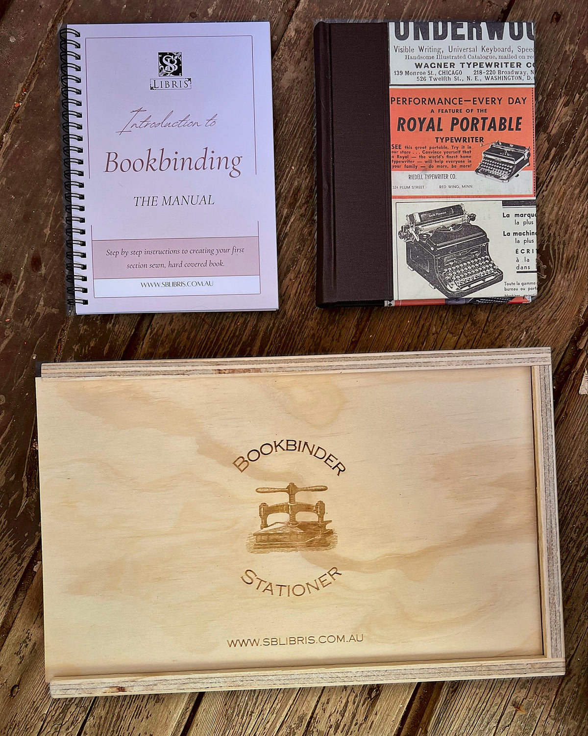 Engraved plywood toolbox, bookbinding manual and a finished hand-bound book from the SB Libris kit