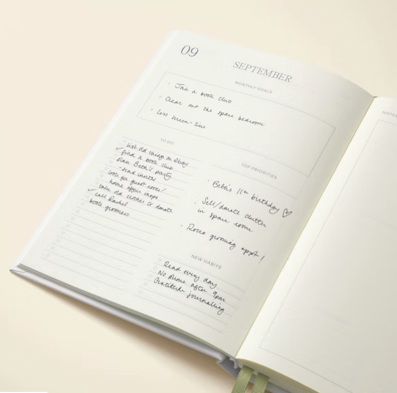 Open planner or journal with handwritten notes on a light background