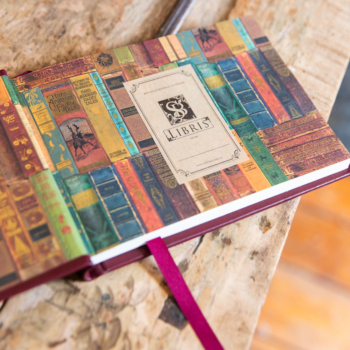 Notebook with colorful cover design on a wooden surface
