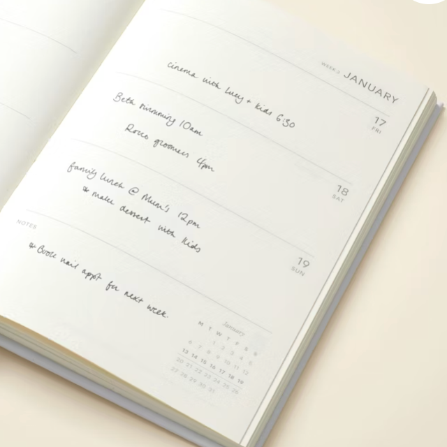 Open planner with handwritten notes on a light background