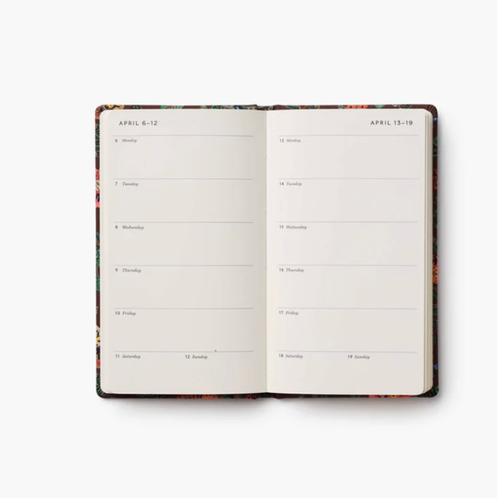 Open planner with weekly schedule on a white background